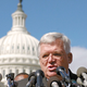 Hastert addresses reporters.